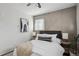 Comfortable bedroom with neutral tones, a fan, and a decorative geometric accent wall at 1680 Syracuse St, Denver, CO 80220