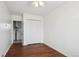 Bright bedroom with wood floors, ceiling fan, closet and easy access to laundry and kitchen at 1680 Syracuse St, Denver, CO 80220