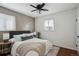 Comfortable bedroom featuring stylish accent wall, ceiling fan, and ample natural light at 1680 Syracuse St, Denver, CO 80220