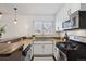 Bright kitchen featuring stainless steel appliances, granite countertops, and crisp white cabinets at 1680 Syracuse St, Denver, CO 80220