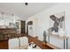 Open-concept living room with stylish decor, leading to a modern kitchen with a sliding barn door at 1680 Syracuse St, Denver, CO 80220