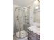 Modern bathroom featuring glass enclosed shower stall with multiple shelves and modern fixtures at 1680 Syracuse St, Denver, CO 80220