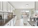 Bright kitchen with granite countertops, stainless steel sink, and a view at 217 Ford St, Golden, CO 80403