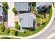 Aerial view of a home with a lush backyard, patio, and brick-paved driveway in a residential area at 18173 E 104Th Way, Commerce City, CO 80022