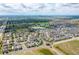 Expansive aerial view showcasing the community, lake, and red barn nestled in a well-designed neighborhood at 18173 E 104Th Way, Commerce City, CO 80022