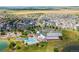 Sprawling community aerial view showcasing a pool, clubhouse, lake, and expansive parks, ideal for recreation at 18173 E 104Th Way, Commerce City, CO 80022