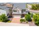 Aerial view of a charming two-story home featuring a brick driveway, attractive landscaping, and community at 18173 E 104Th Way, Commerce City, CO 80022