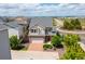 Aerial view of a two-story home with a brick driveway, beautiful landscaping, and neighborhood at 18173 E 104Th Way, Commerce City, CO 80022