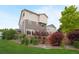 Scenic backyard with lush green grass, mature trees, privacy fence, and a charming patio area at 18173 E 104Th Way, Commerce City, CO 80022