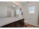 Bathroom featuring a single sink, dark wood cabinets, and a shower-tub combo at 18173 E 104Th Way, Commerce City, CO 80022