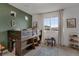 bedroom with cool green feature wall and a rustic wood bunk bed and play area at 18173 E 104Th Way, Commerce City, CO 80022