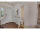 Inviting entryway with wood floors, white doors, and a convenient half bathroom at 18173 E 104Th Way, Commerce City, CO 80022