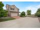 Two-story home featuring a paved brick driveway, spacious parking, and well-maintained landscaping at 18173 E 104Th Way, Commerce City, CO 80022