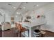 Bright kitchen with an island, seating, and stainless steel appliances that flows to living room at 18173 E 104Th Way, Commerce City, CO 80022
