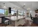 Spacious kitchen with a large island, pendant lights, and modern fixtures, open to the living area at 18173 E 104Th Way, Commerce City, CO 80022