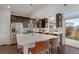 Open-concept kitchen with a large island, stainless appliances, and access to the outdoor patio at 18173 E 104Th Way, Commerce City, CO 80022