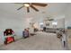 Bright living room features a ceiling fan, neutral carpet, and plentiful space for toys and Gathering activities at 18173 E 104Th Way, Commerce City, CO 80022