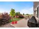 Paver patio featuring stylish patio furniture and landscaped backyard with privacy fence at 18173 E 104Th Way, Commerce City, CO 80022