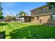 Spacious backyard with a covered patio and brick house at 6240 W 110Th Pl, Westminster, CO 80020