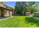 Wide view of the backyard with a storage shed and lush green grass at 6240 W 110Th Pl, Westminster, CO 80020