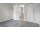 Bedroom with new carpet, closet doors, and entrance to hallway at 6240 W 110Th Pl, Westminster, CO 80020