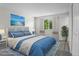 Comfortable bedroom featuring a large window, soothing blue decor, and plush bedding at 6240 W 110Th Pl, Westminster, CO 80020