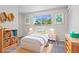 Bright bedroom featuring colorful artwork, built-in shelving, and a cozy bed at 6240 W 110Th Pl, Westminster, CO 80020