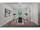 Bright dining room with a glass table, modern light fixture, and hardwood floors at 6240 W 110Th Pl, Westminster, CO 80020