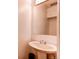 Powder room with a pedestal sink, mirror, and toilet at 8798 Chase Dr # 2, Arvada, CO 80003