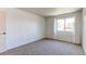 Bright bedroom with fresh neutral carpet features a window and freshly painted white walls at 8798 Chase Dr # 2, Arvada, CO 80003
