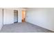 Bedroom features neutral carpet, closet space with sliding doors, and a glimpse of an ensuite bathroom at 8798 Chase Dr # 2, Arvada, CO 80003