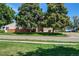 Exterior shot of the community buildings, showing the well-maintained lawns and mature trees at 8798 Chase Dr # 2, Arvada, CO 80003