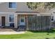 Inviting townhome entrance with a small fenced yard and lush green lawn at 8798 Chase Dr # 2, Arvada, CO 80003