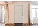 Bright living room showcasing wood floors, white door and trim, and natural light at 8798 Chase Dr # 2, Arvada, CO 80003
