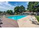 Community pool with ample lounge chairs for relaxation and enjoying the outdoors at 8798 Chase Dr # 2, Arvada, CO 80003