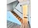 Staircase featuring a wood floor and leading to the upper level at 8798 Chase Dr # 2, Arvada, CO 80003
