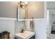 Charming bathroom with updated vanity, decorative mirror, and neutral tones creating a serene atmosphere at 6970 Upham St, Arvada, CO 80003