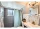 Well-lit bathroom featuring modern fixtures, stylish tiling, and a shower with a calming blue curtain at 6970 Upham St, Arvada, CO 80003