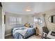 Bright bedroom featuring a comfortable bed, window, and desk, perfect for relaxation and productivity at 6970 Upham St, Arvada, CO 80003