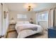 Cozy bedroom featuring natural light and stylish decor elements and a queen-sized bed at 6970 Upham St, Arvada, CO 80003