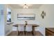 Dining area with a modern table and chairs, complemented by stylish decor at 6970 Upham St, Arvada, CO 80003