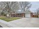 Beautiful brick home with an attached garage and a manicured lawn at 6970 Upham St, Arvada, CO 80003