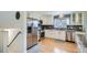Modern kitchen with stainless steel appliances, granite countertops, and ample cabinet space at 6970 Upham St, Arvada, CO 80003