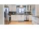 Beautiful kitchen with stainless steel appliances, granite countertops, and hardwood floors at 6970 Upham St, Arvada, CO 80003