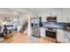 Bright kitchen with stainless steel appliances, granite countertops, and hardwood floors at 6970 Upham St, Arvada, CO 80003