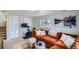 Comfortable living room with an orange sectional, exercise bike, and modern decor at 6970 Upham St, Arvada, CO 80003