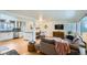 Bright and airy living room with hardwood floors, open to the kitchen and dining area at 6970 Upham St, Arvada, CO 80003