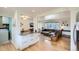 Open-concept living space featuring a kitchen island, dining area, and comfortable living room at 6970 Upham St, Arvada, CO 80003