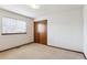 Simple bedroom with neutral walls, carpet, and window at 9748 W Peakview Dr, Littleton, CO 80123