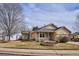 Tan one-story house with a covered porch and landscaped yard at 9748 W Peakview Dr, Littleton, CO 80123